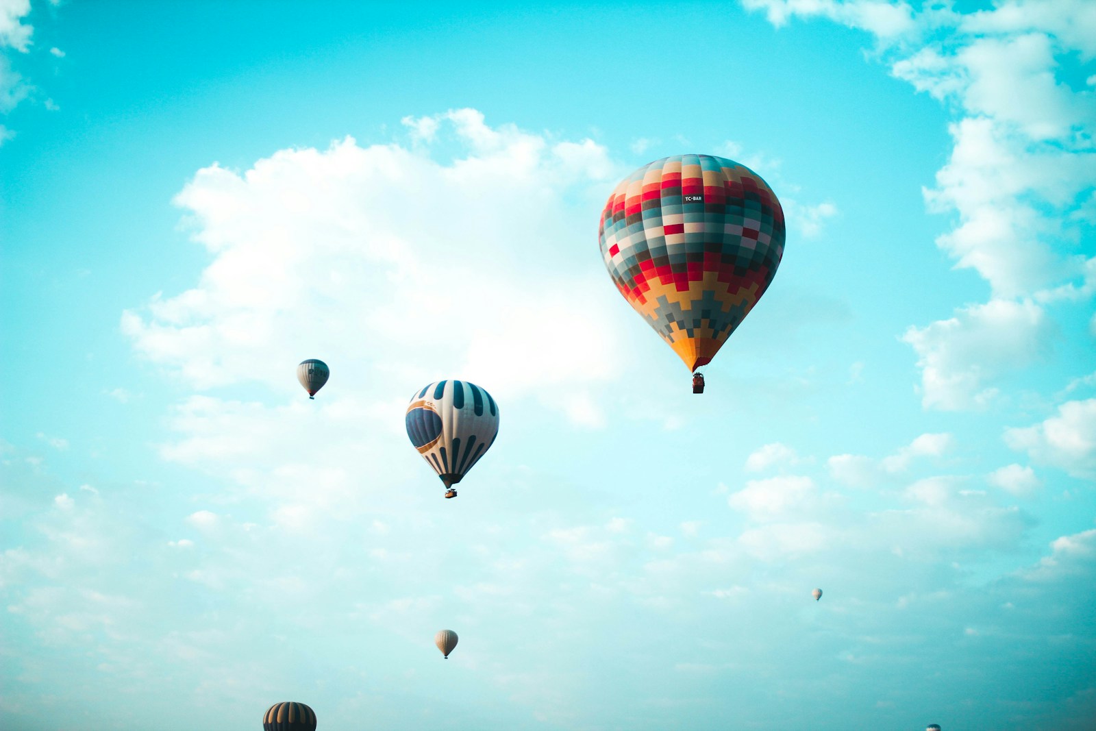 assorted hot air balloons flying at high altitude during daytime